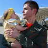 Chris Nisch of VFA-94, The Mighty Shrikes, holds his 7-month-old daughter Emma Joy for the first time.